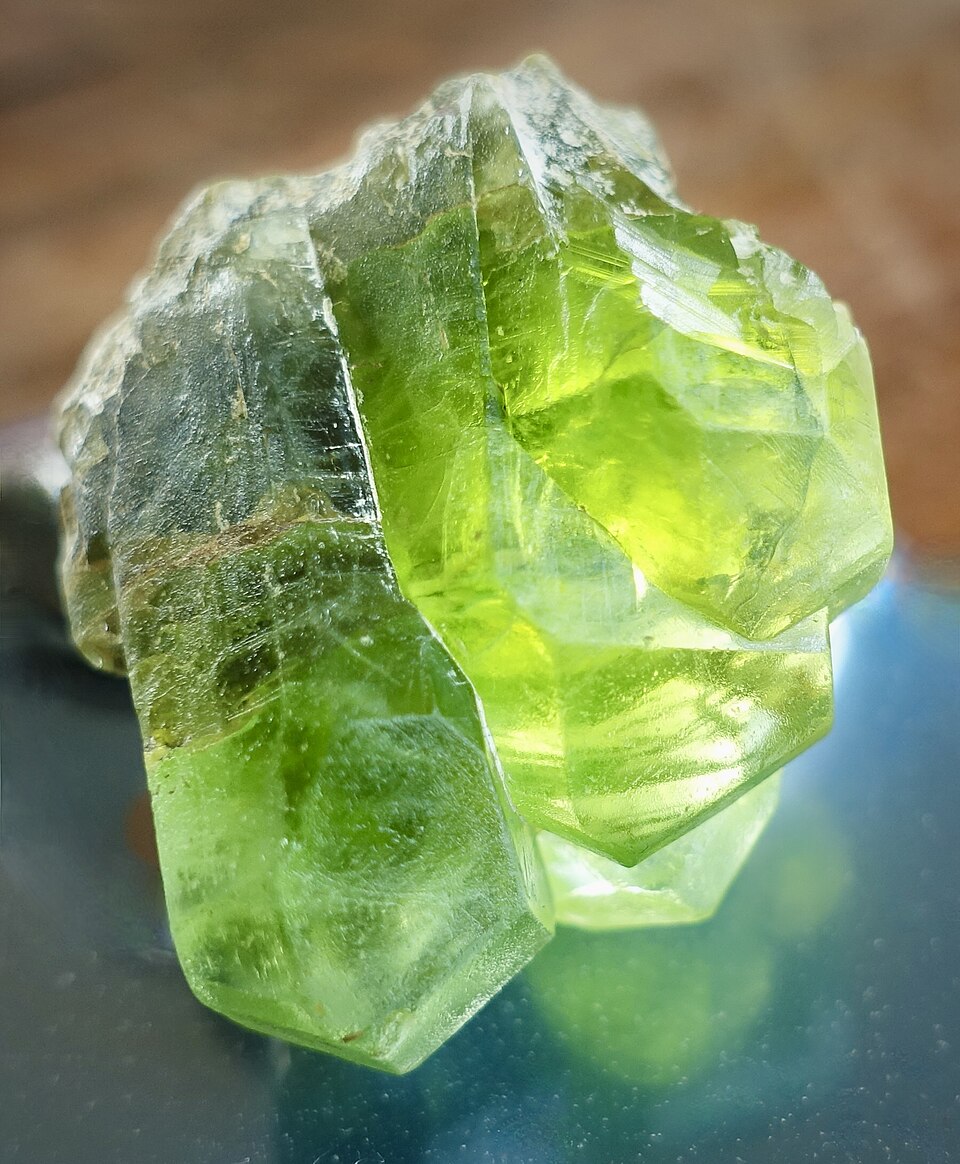A cluster of translucent green peridot crystals.