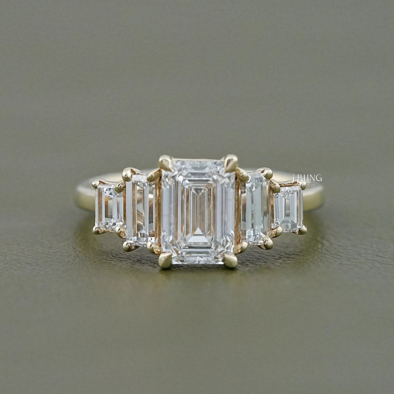 A ring with an emerald-cut diamond and trapezoid side stones.