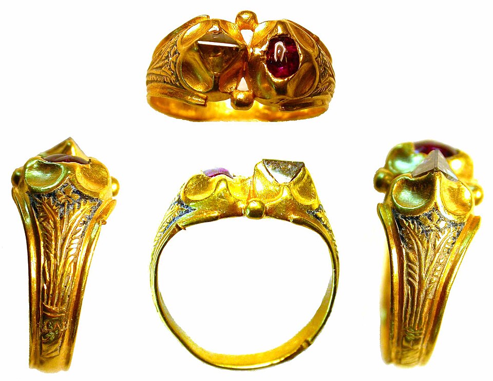 Four views of a late medieval gold ring with a pale diamond and a red stone.