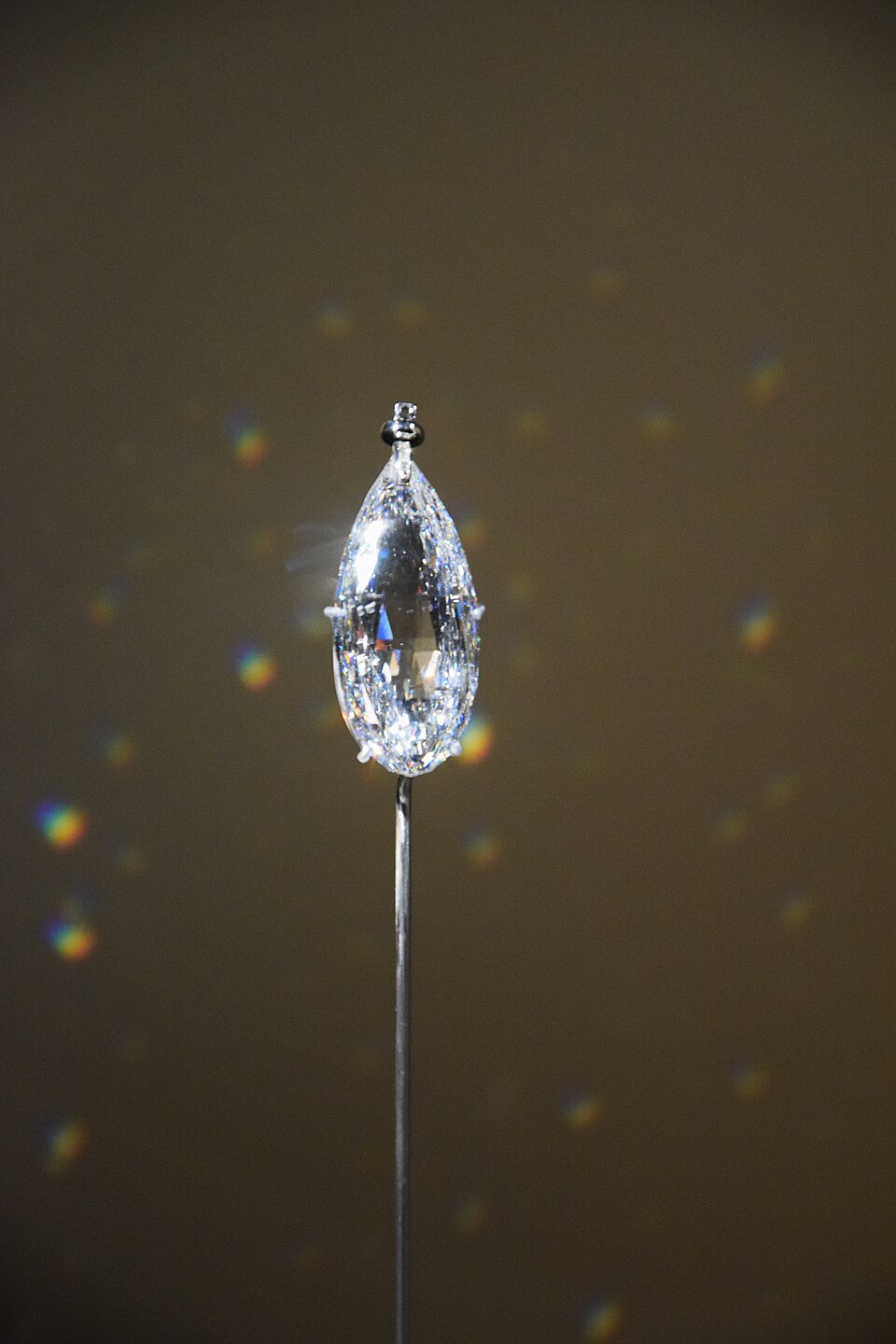 A pear-shaped diamond mounted on a museum pin.