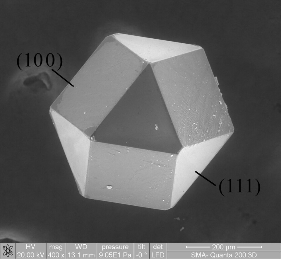 A microscope image of a cuboctahedral diamond crystal with facet labels.
