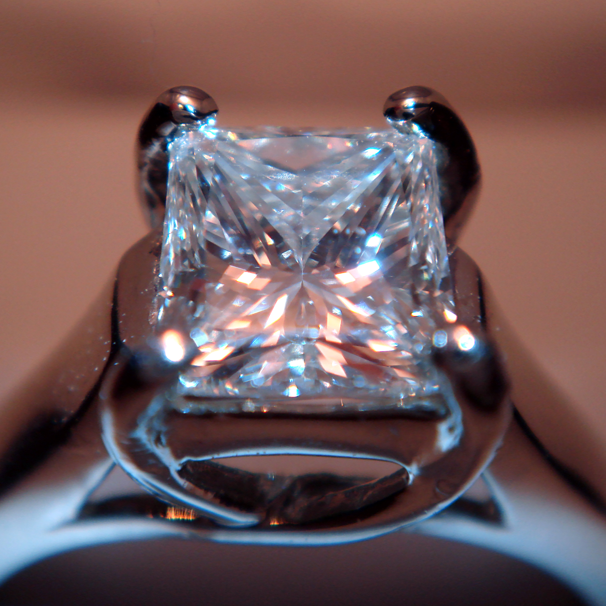 A square princess-cut diamond in a four-prong ring.