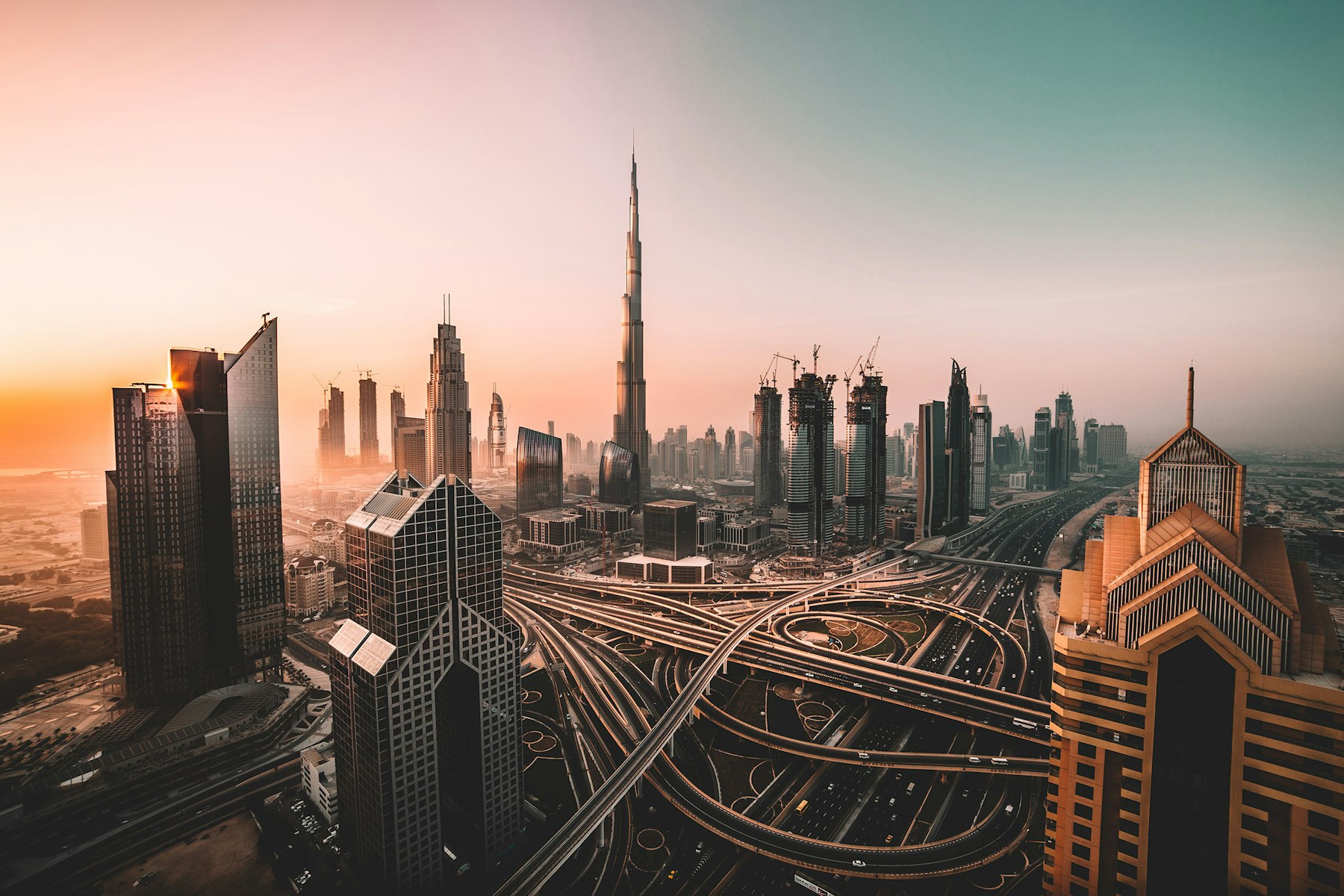 Dubai skyline and highways at sunset.