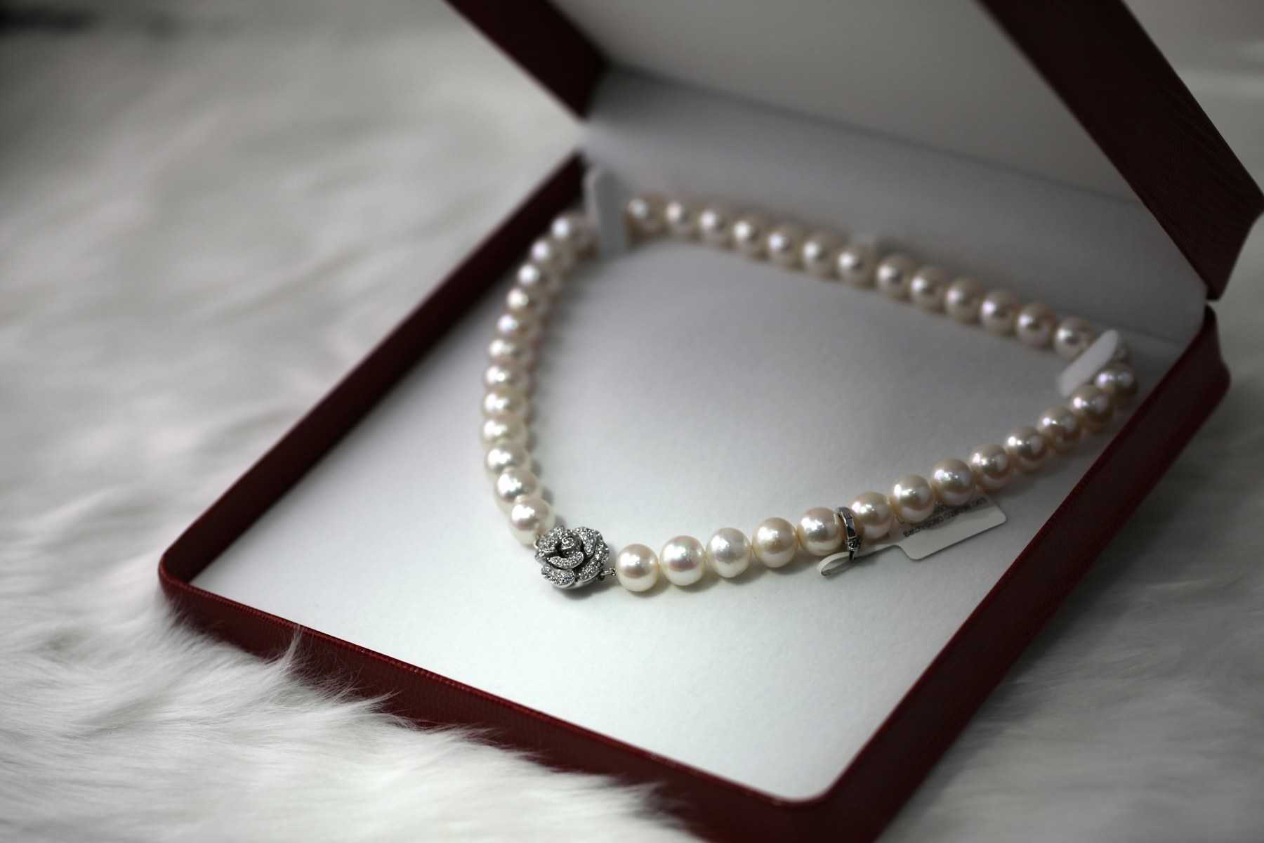 A strand of white pearls in a box.